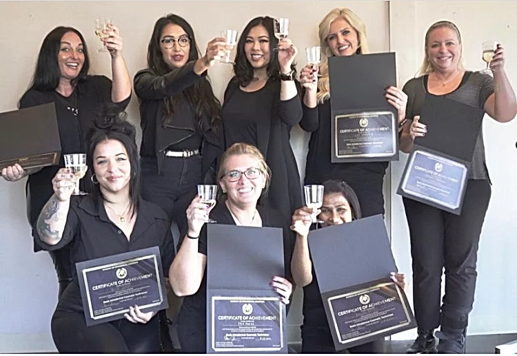 Hotaru and 6 students holding their permanent makeup certificates