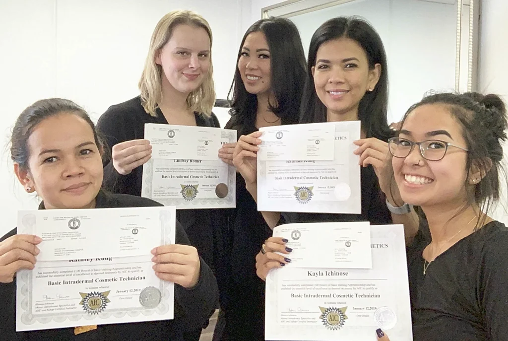 Hotaru and 4 students holding their permanent makeup certificates